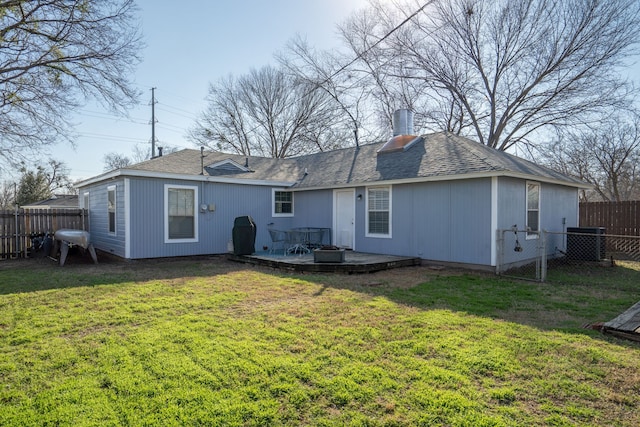 rear view of house featuring a fenced backyard, a yard, a chimney, and central AC unit