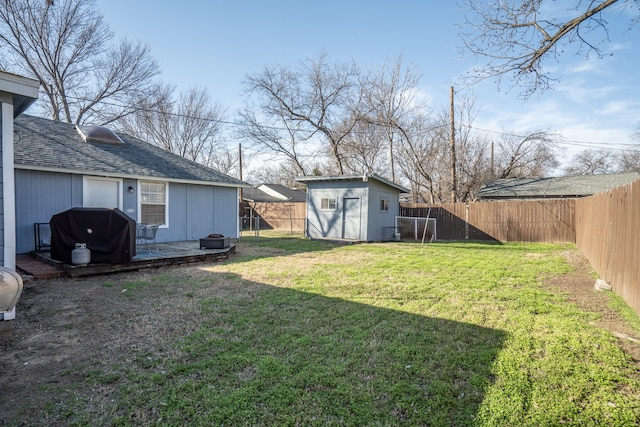 view of yard featuring a fenced backyard, cooling unit, a wooden deck, a shed, and an outdoor structure