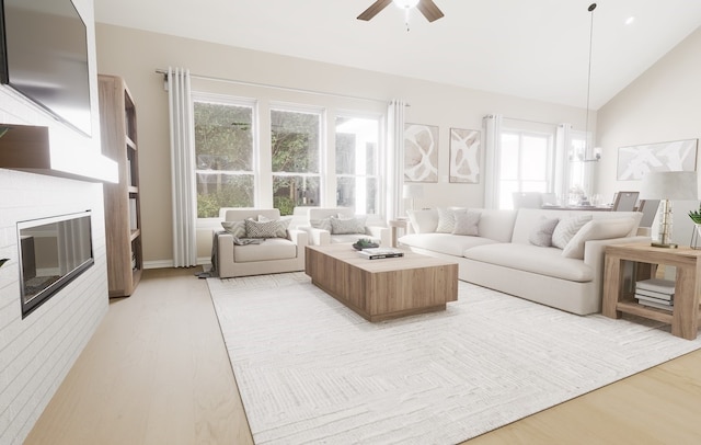 174 Fan Mill Trl, Weatherford, TX 76085 - living room with light wood-style floors, a ceiling fan, a glass covered fireplace, and lofted ceiling
