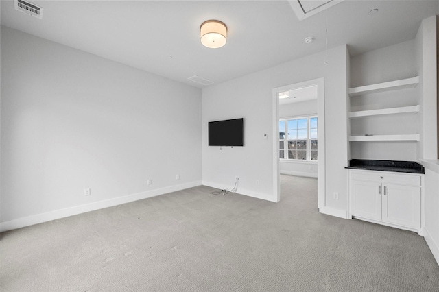 3200 Ross Ave Unit 40, Dallas, TX 75204 - unfurnished living room featuring attic access, light carpet, and baseboards