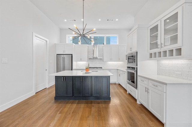 3200 Ross Ave Unit 40, Dallas, TX 75204 - kitchen featuring stainless steel appliances, wall chimney range hood, white cabinetry, light countertops, and recessed lighting