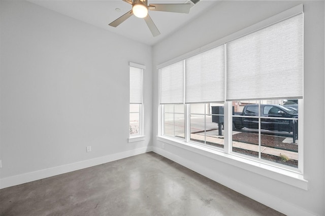 3200 Ross Ave Unit 40, Dallas, TX 75204 - empty room featuring baseboards, finished concrete flooring, plenty of natural light, and ceiling fan