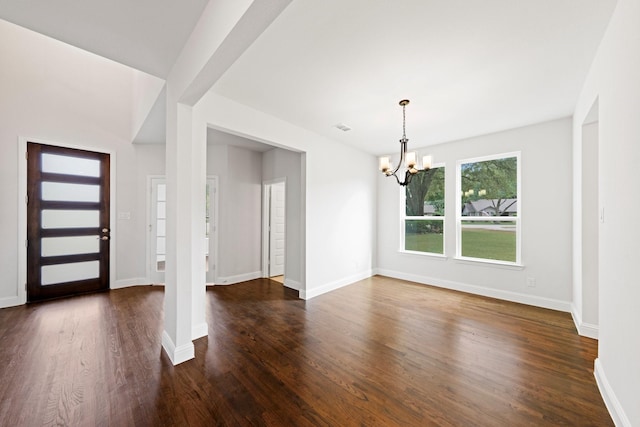 foyer entrance with an inviting chandelier, visible vents, baseboards, and dark wood-type flooring