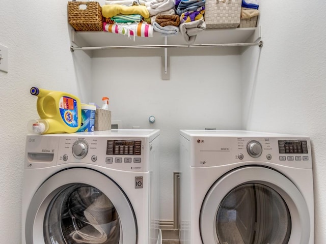 clothes washing area featuring laundry area and washing machine and dryer