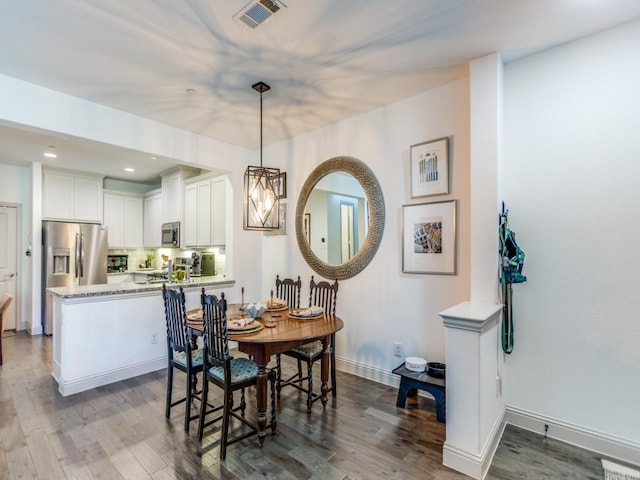 dining room with recessed lighting, visible vents, baseboards, and wood finished floors