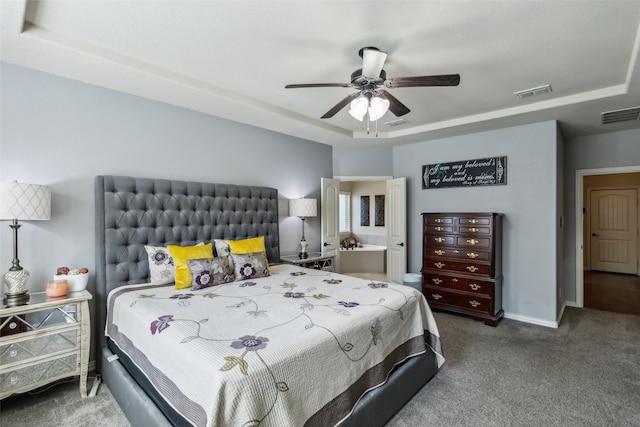 bedroom with ceiling fan, carpet floors, a raised ceiling, and visible vents