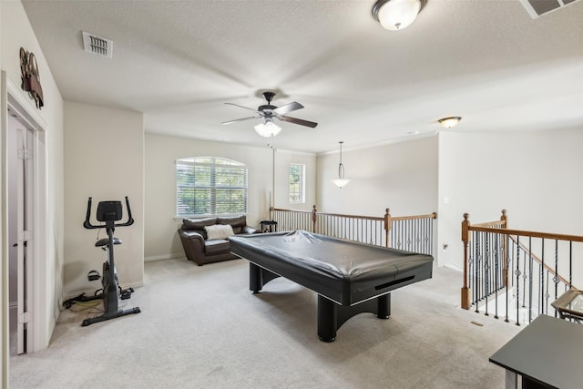 rec room with visible vents, light carpet, and a textured ceiling