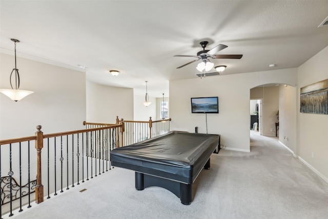 recreation room with light carpet, baseboards, visible vents, and arched walkways