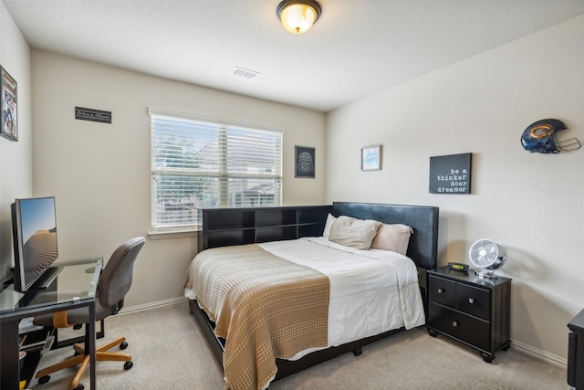 bedroom featuring light carpet, visible vents, and baseboards