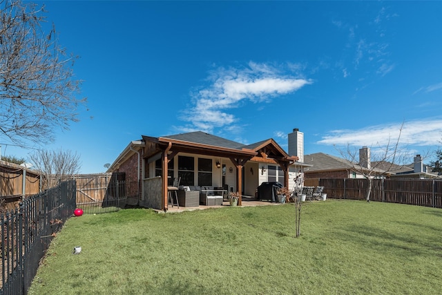 back of property featuring a patio area, a fenced backyard, an outdoor living space, and a lawn