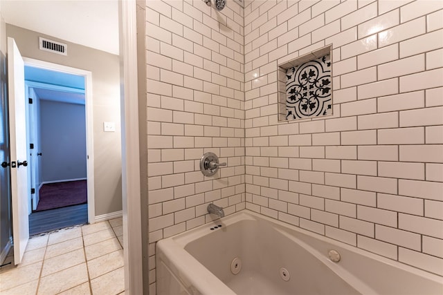 bathroom featuring a combined bath / shower with jetted tub, visible vents, baseboards, and tile patterned floors