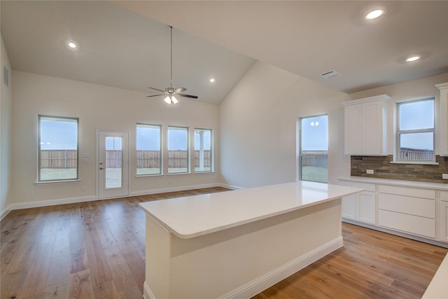 kitchen featuring light countertops, a kitchen island, and white cabinetry