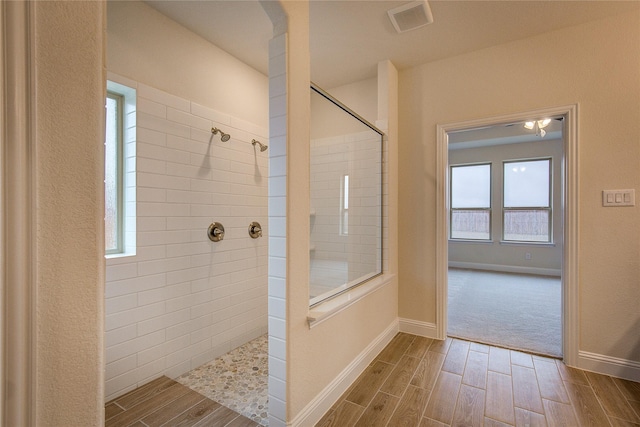 full bath with wood finish floors, visible vents, baseboards, and a walk in shower