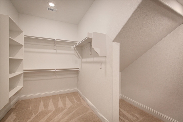 walk in closet with light carpet and visible vents