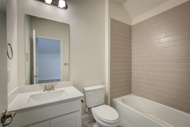 bathroom with a textured wall, vanity, toilet, and bathing tub / shower combination