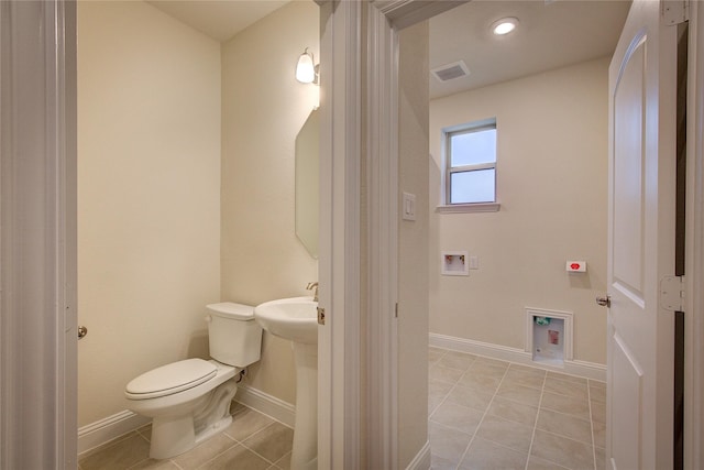 bathroom with toilet, baseboards, visible vents, and tile patterned floors