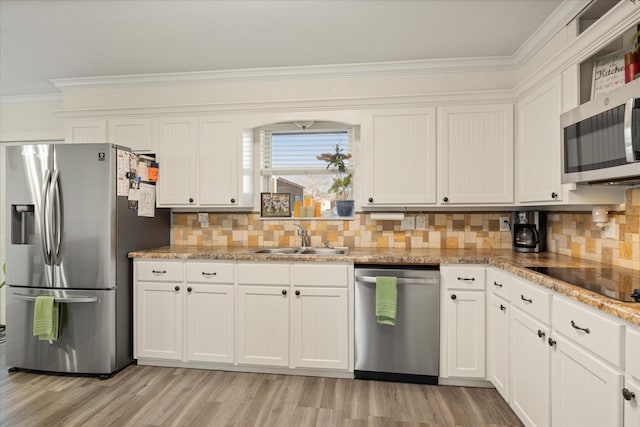 kitchen with stainless steel appliances, white cabinets, and a sink