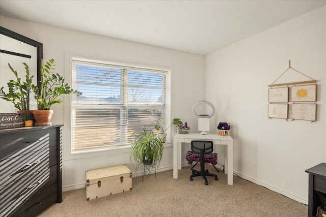 home office with baseboards and light colored carpet