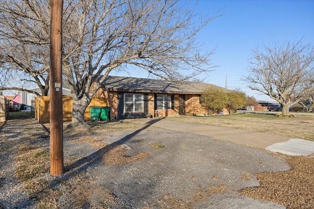 view of front facade featuring aphalt driveway and brick siding