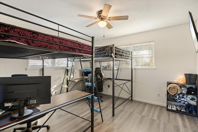 bedroom with baseboards and wood finished floors