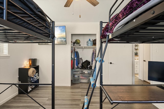 bedroom featuring baseboards and wood finished floors