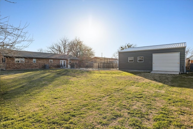 view of yard with fence and an outdoor structure