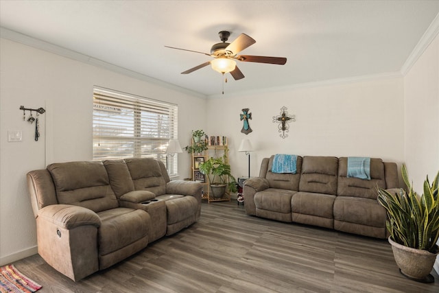 living room with dark wood-type flooring, ornamental molding, baseboards, and ceiling fan