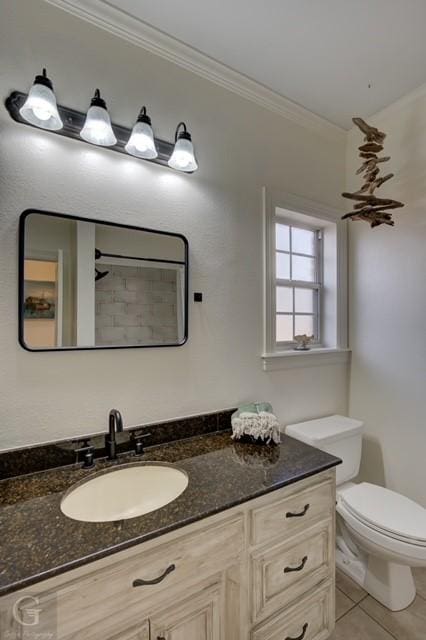 bathroom featuring toilet, tile patterned flooring, ornamental molding, and vanity