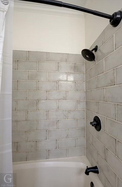 full bathroom featuring ornamental molding and shower / tub combo