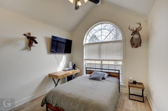 bedroom with light wood-style floors, baseboards, and vaulted ceiling