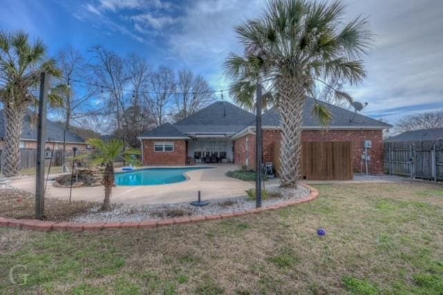 view of swimming pool featuring fence, a fenced in pool, and a yard