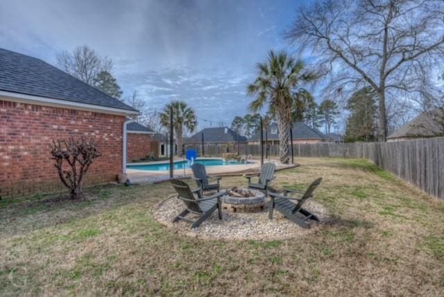 view of yard featuring an outdoor fire pit, a fenced backyard, and a fenced in pool