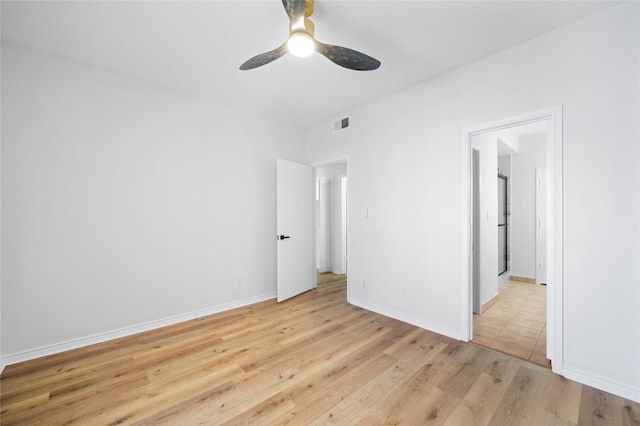 unfurnished bedroom with visible vents, ceiling fan, light wood-style flooring, and baseboards