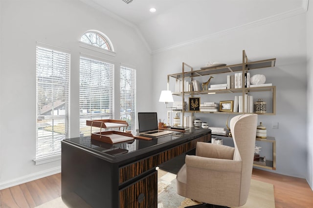 office space with crown molding, baseboards, vaulted ceiling, and wood finished floors