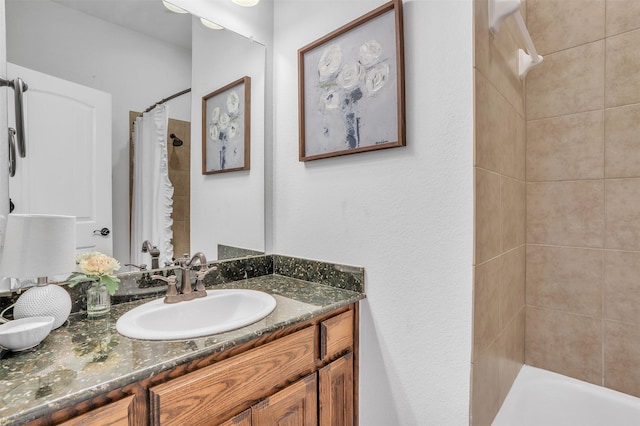 full bathroom featuring a shower with curtain, a tub, and vanity