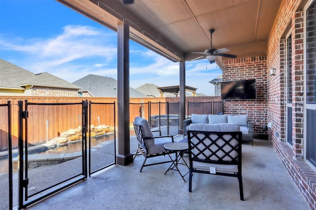 view of patio featuring an outdoor hangout area, fence, and a ceiling fan