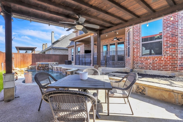 view of patio / terrace featuring outdoor dining space, a fenced backyard, and ceiling fan