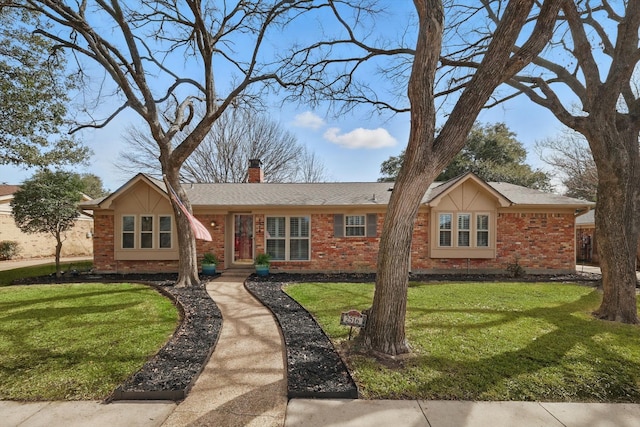 ranch-style house featuring brick siding, a chimney, and a front lawn