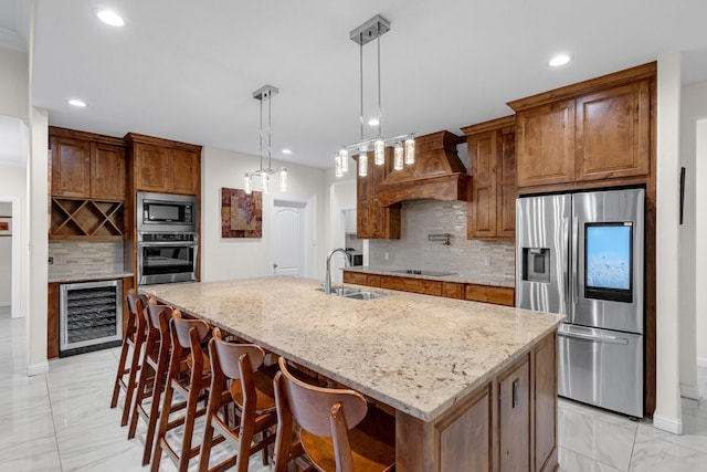 kitchen featuring beverage cooler, appliances with stainless steel finishes, light stone counters, custom exhaust hood, and a sink