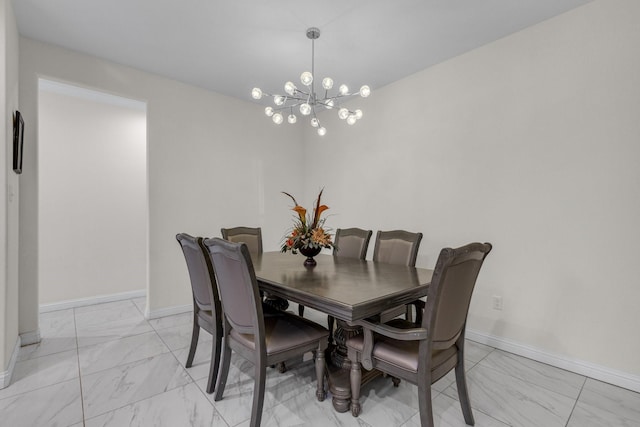 dining space with marble finish floor, baseboards, and an inviting chandelier