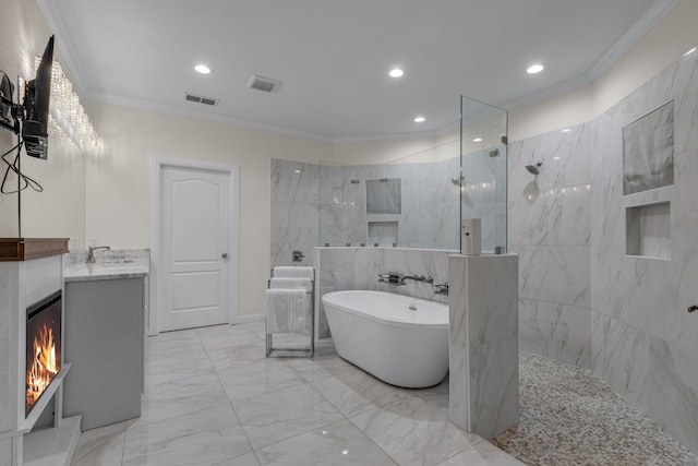 bathroom featuring marble finish floor, a marble finish shower, a freestanding bath, ornamental molding, and vanity