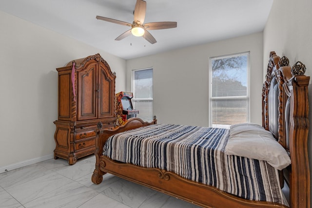 bedroom featuring marble finish floor, baseboards, and a ceiling fan