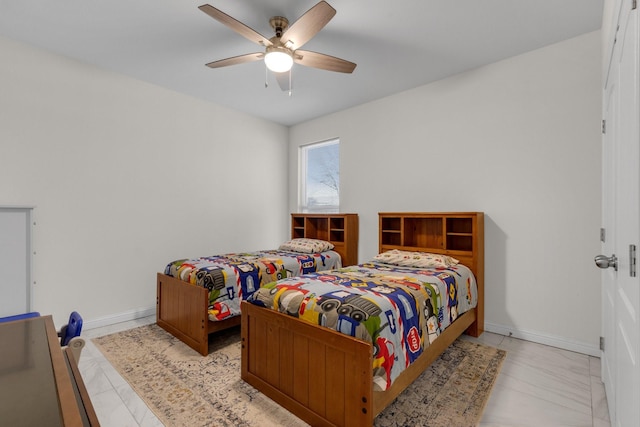 bedroom featuring ceiling fan and baseboards