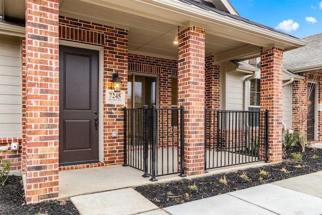 property entrance featuring brick siding