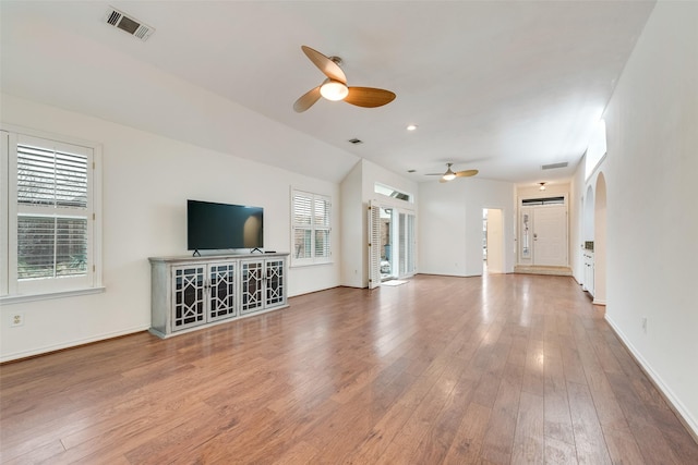 9005 Cumberland Dr, Irving, TX 75063 - unfurnished living room with a ceiling fan, wood finished floors, baseboards, and arched walkways