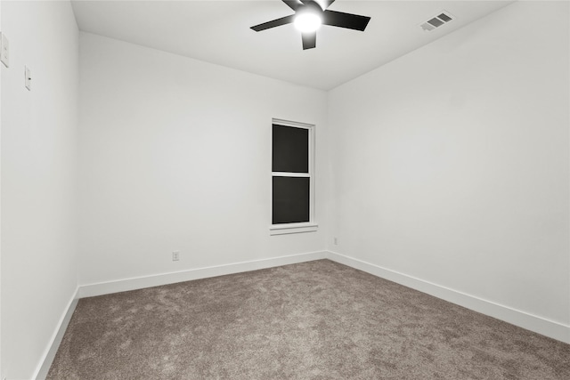 empty room with ceiling fan, carpet flooring, visible vents, and baseboards