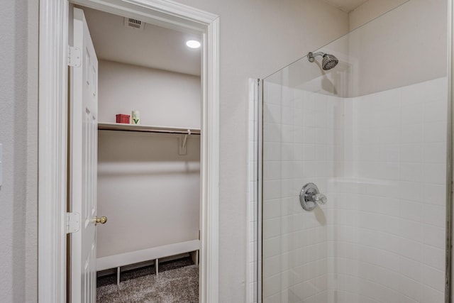 full bathroom with visible vents, a shower stall, baseboards, and a spacious closet