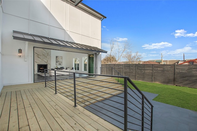 wooden deck with a fenced backyard and a lawn