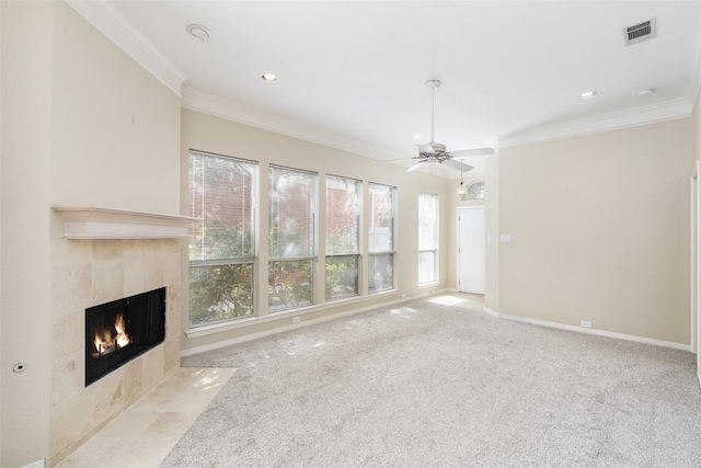 unfurnished living room featuring light carpet, a fireplace, visible vents, and crown molding