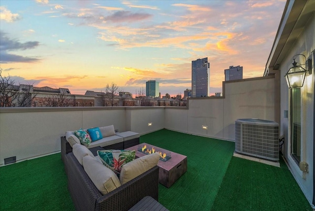 709 E 1st St, Fort Worth, TX 76102 - patio terrace at dusk with central AC, an outdoor living space, and a view of city